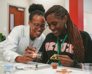Teacher and student examining materials