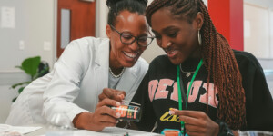Teacher and student examining materials